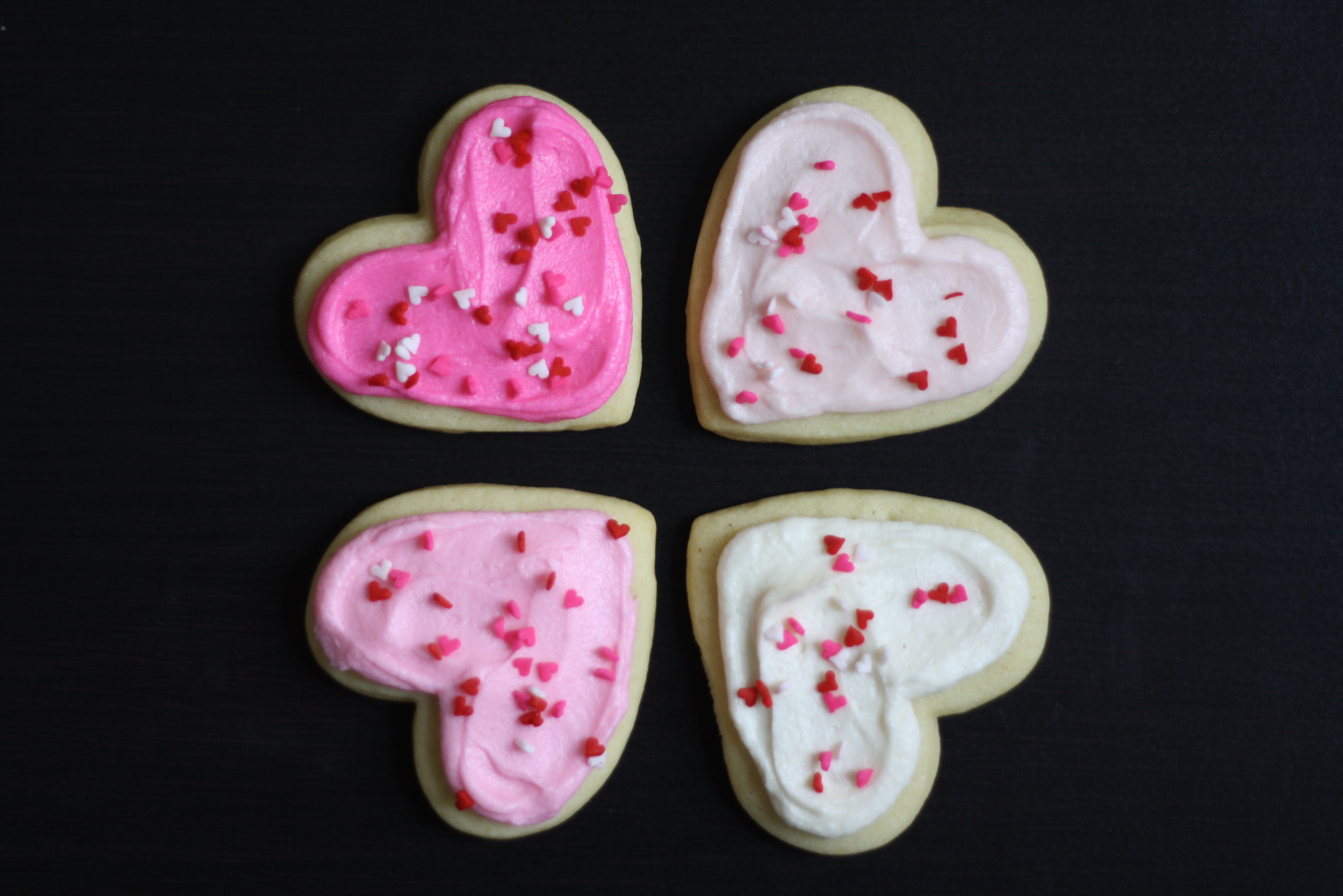 four frosted cookie hearts